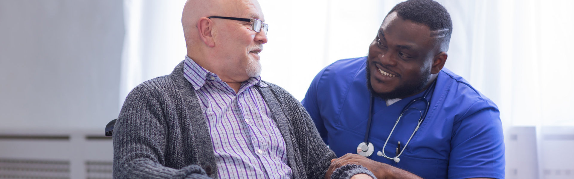 male patient having chat with male caregiver