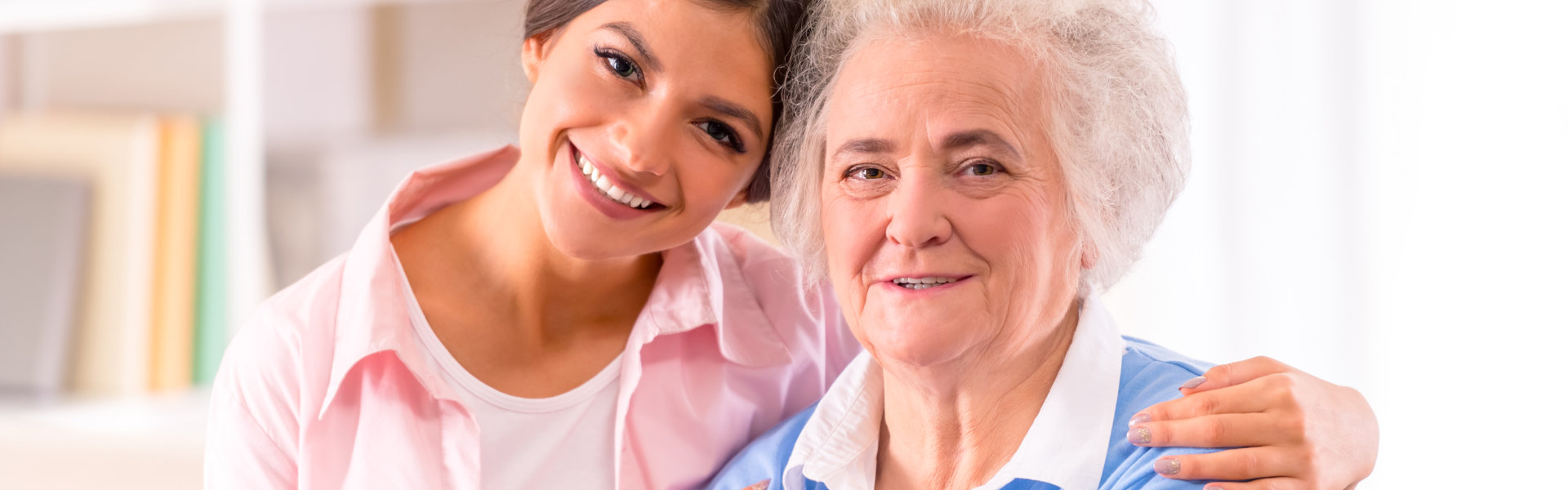 Woman hugging the elderly woman